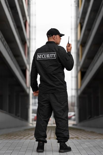 Security Officer standing next to a car